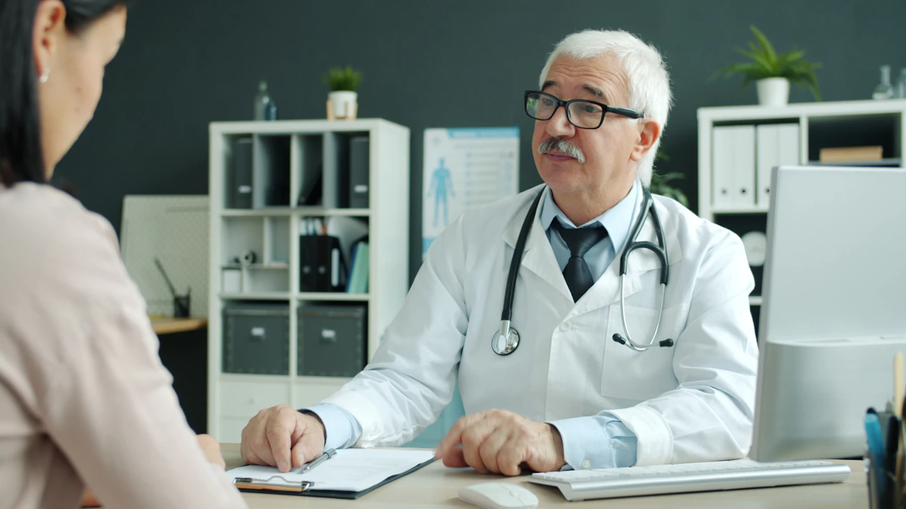 A GP listening carefully to a patient