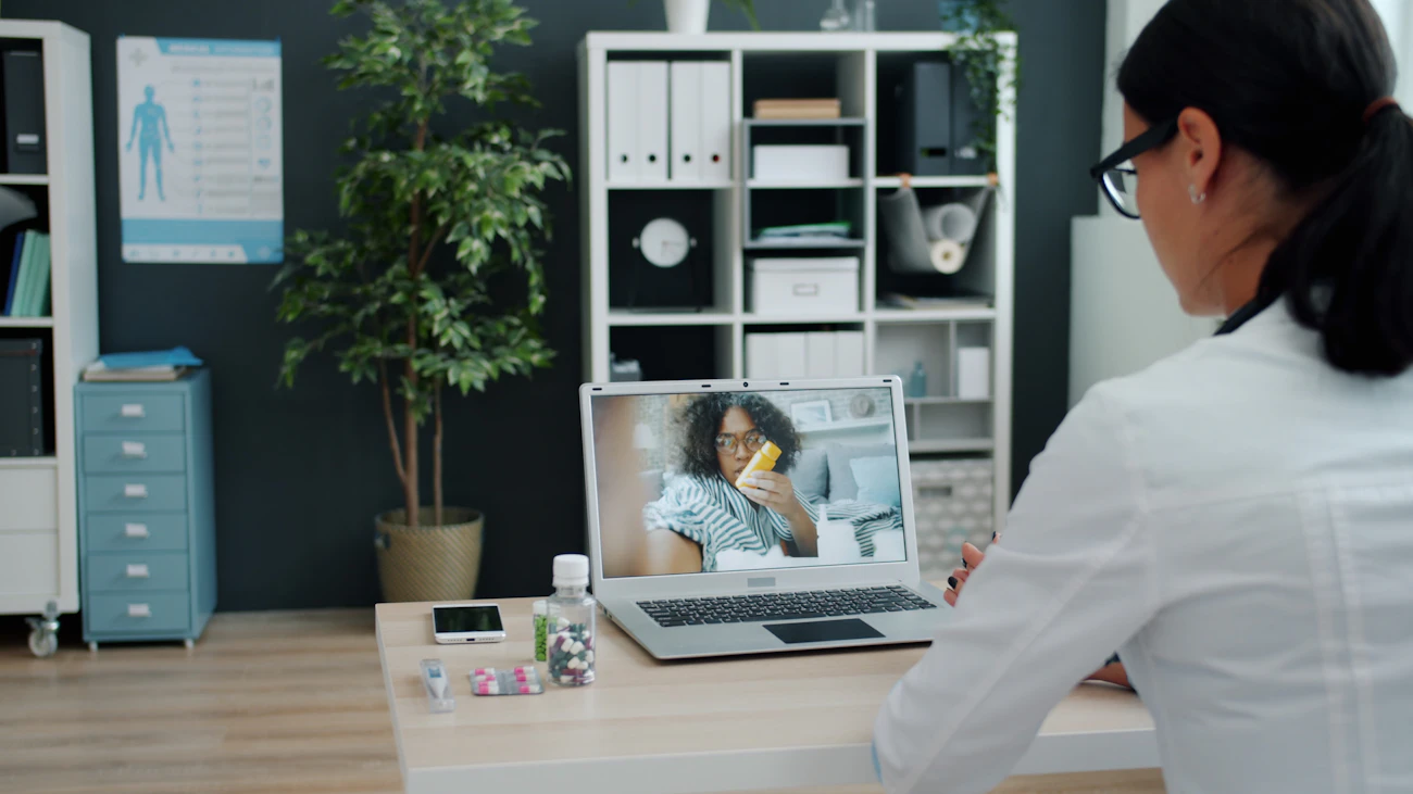 A GP on a video consultation with a patient at home