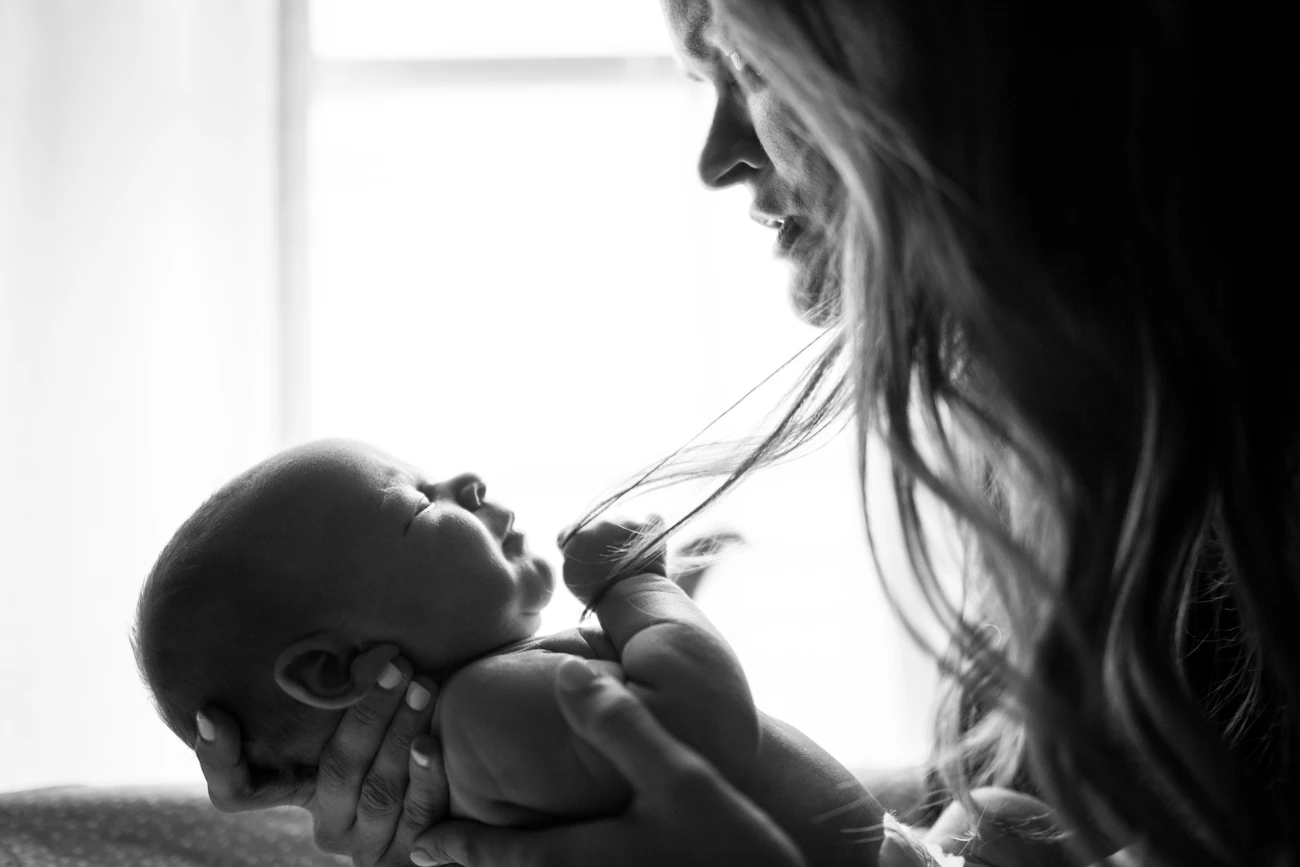 A mother holding her newborn baby