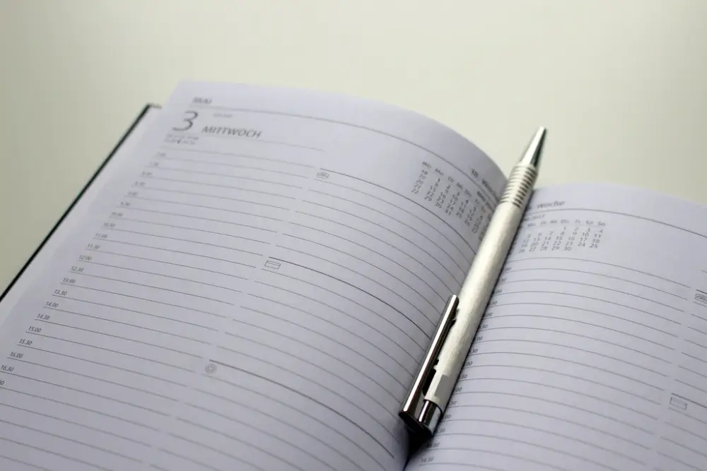 Calendar and pen, representing period delay planning