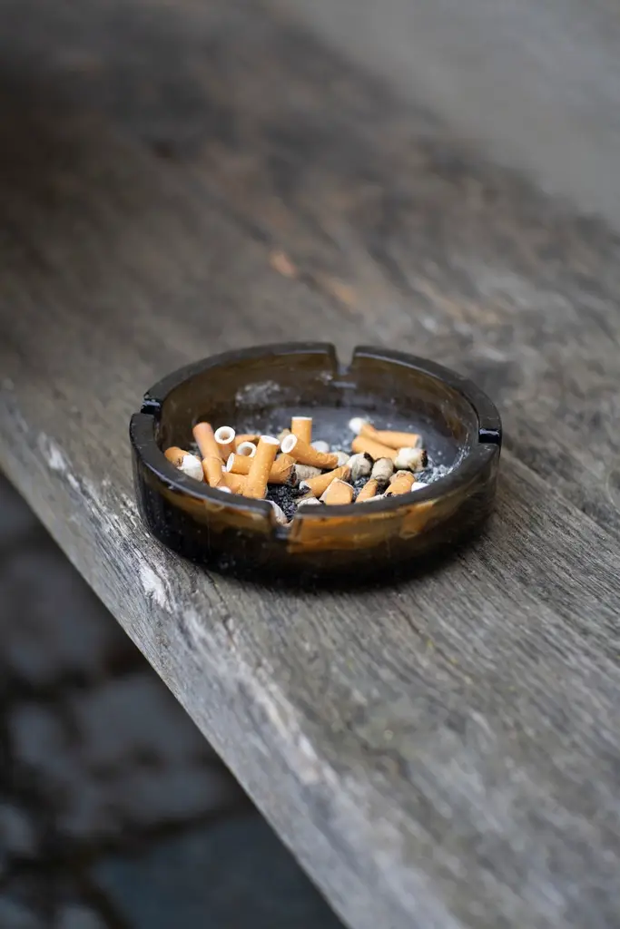 Ashtray with cigarette butts, representing stop smoking support and medication