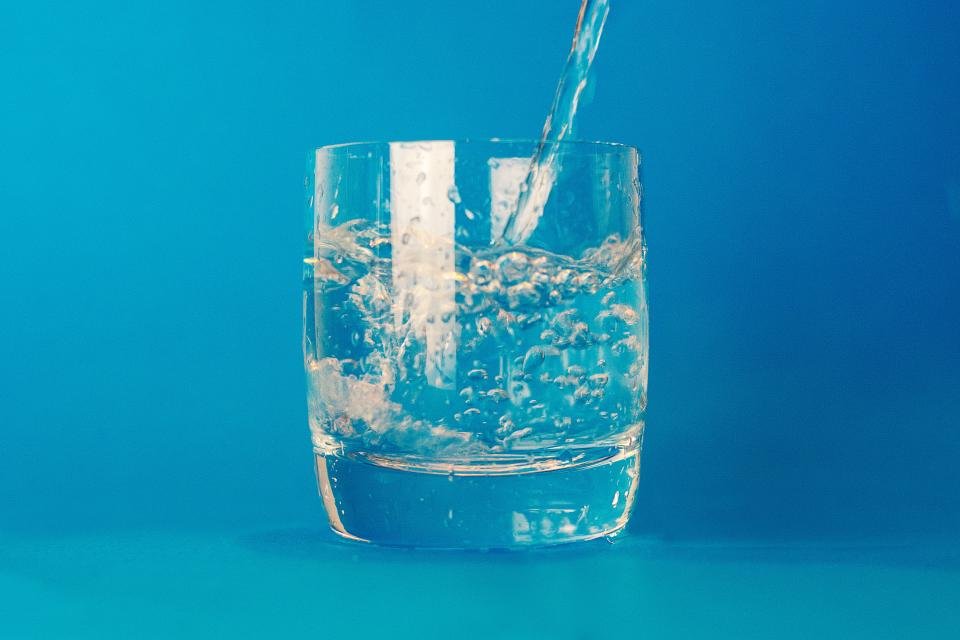 Glass of water being poured, representing UTI and cystitis treatment